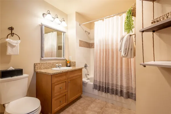a bathroom with a toilet a sink and a mirror
