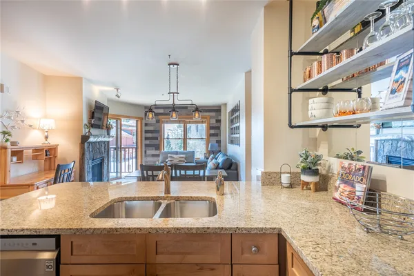 a kitchen with cabinets and chandelier