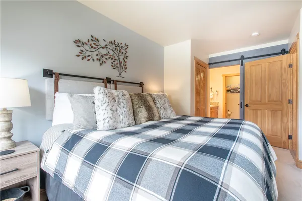 a bedroom with a large bed and a window