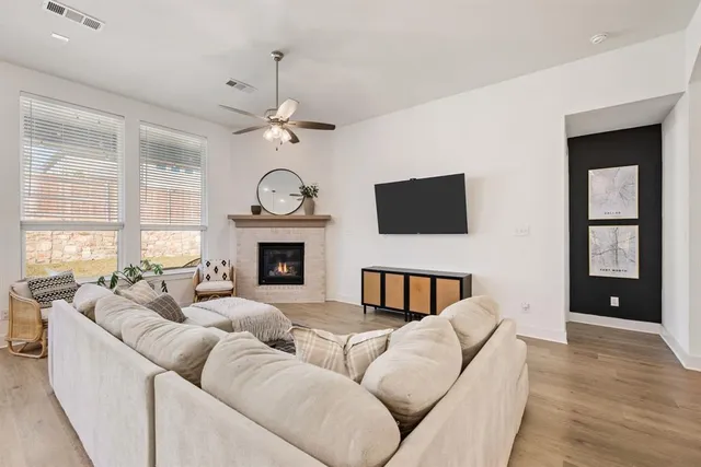 a living room with fireplace furniture and a flat screen tv