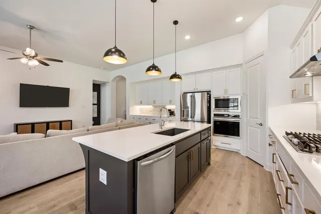 a kitchen with stainless steel appliances kitchen island a large island in the center
