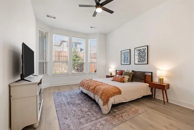 a bedroom with a bed window and flat screen tv