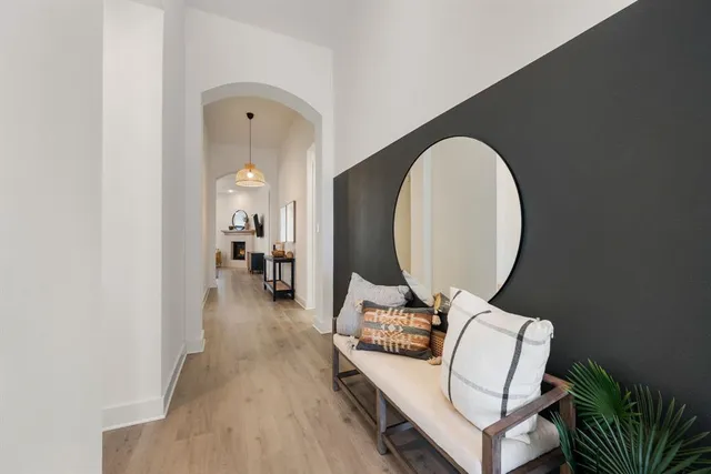 a living room with furniture and a mirror