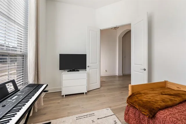 a bedroom with a bed and flat screen tv