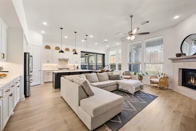 a living room with furniture kitchen view and a fireplace
