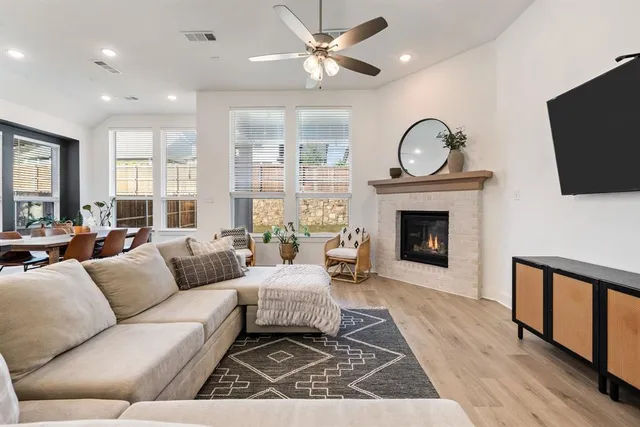 a living room with furniture a flat screen tv and a fireplace