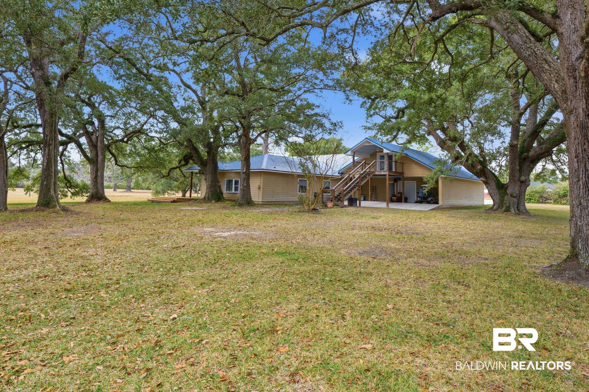 15025 Bellingrath Road Coden, AL 36523 - Photo 22 of 79 Back of property featuring a yard, a deck, and a patio area