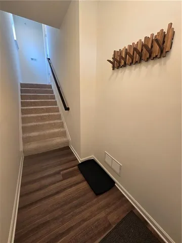 a view of entryway and hall with wooden floor