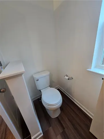 a white toilet sitting next to a bathroom sink