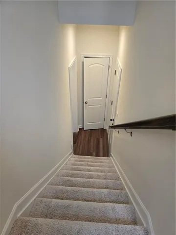 a view of a room with wooden floor and white walls
