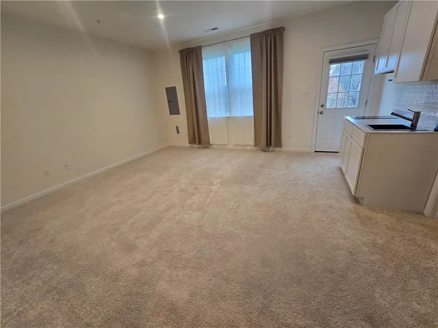 a view of a kitchen with an empty space and a window