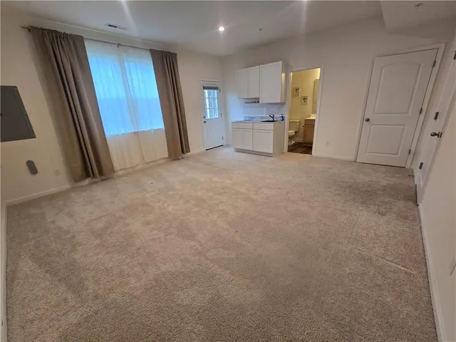 a view of a kitchen with a sink and a refrigerator