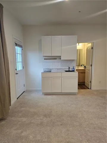 a view of a kitchen with a sink cabinets and a window