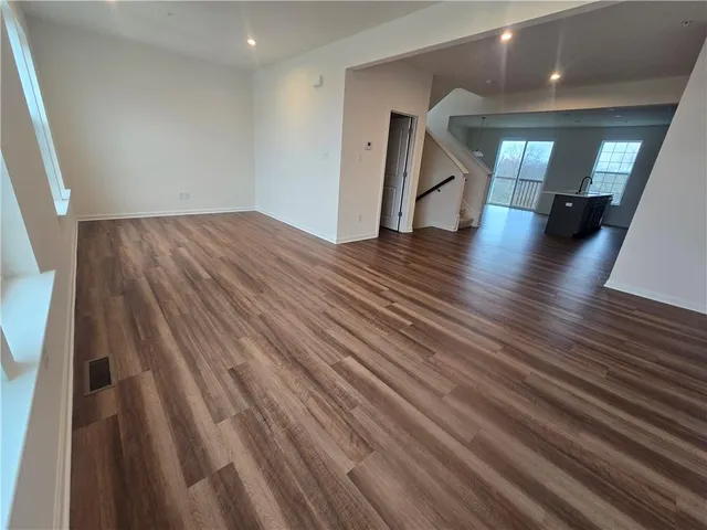a view of an empty room and wooden floor