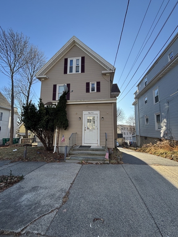 54 Tudor Street, Unit 1 Lynn, MA 01902 - Photo 1 of 10 a front view of a house with a yard