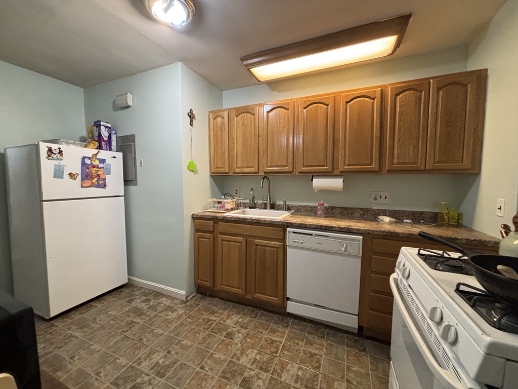 54 Tudor Street, Unit 1 Lynn, MA 01902 - Photo 2 of 10 a kitchen with a refrigerator stove and sink