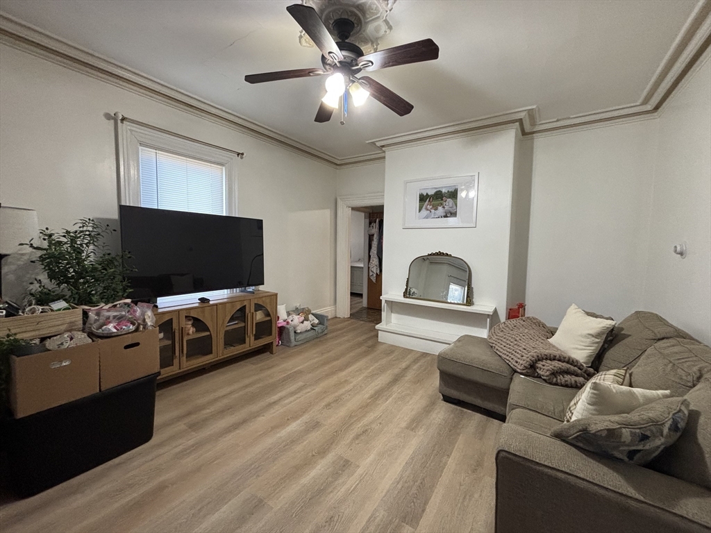 54 Tudor Street, Unit 1 Lynn, MA 01902 - Photo 5 of 10 a living room with furniture and a flat screen tv
