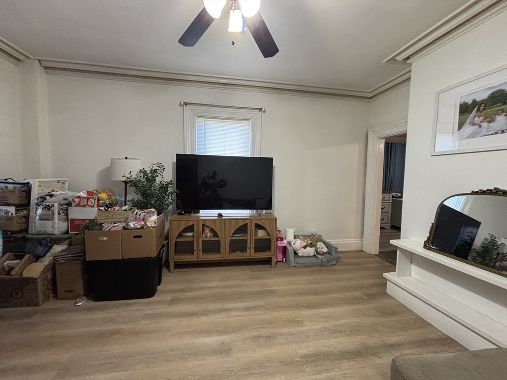 54 Tudor Street, Unit 1 Lynn, MA 01902 - Photo 7 of 10 a living room with furniture and a flat screen tv