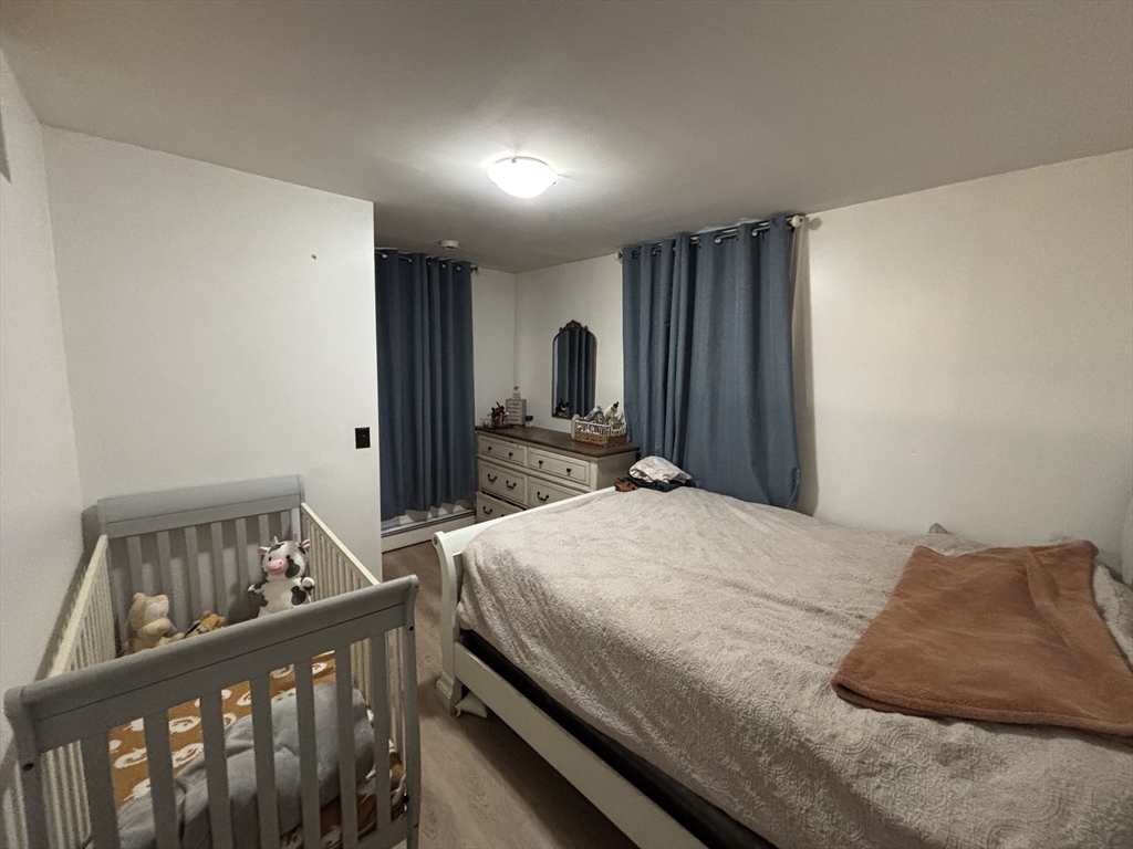 54 Tudor Street, Unit 1 Lynn, MA 01902 - Photo 9 of 10 a bedroom with a bed and a dresser