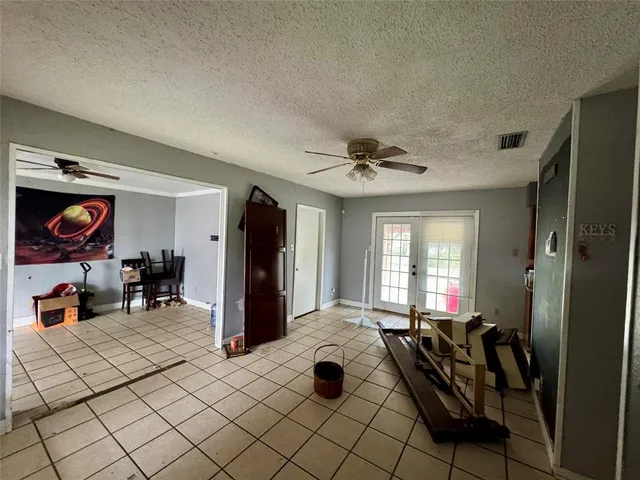 a view of a livingroom with workspace and a window