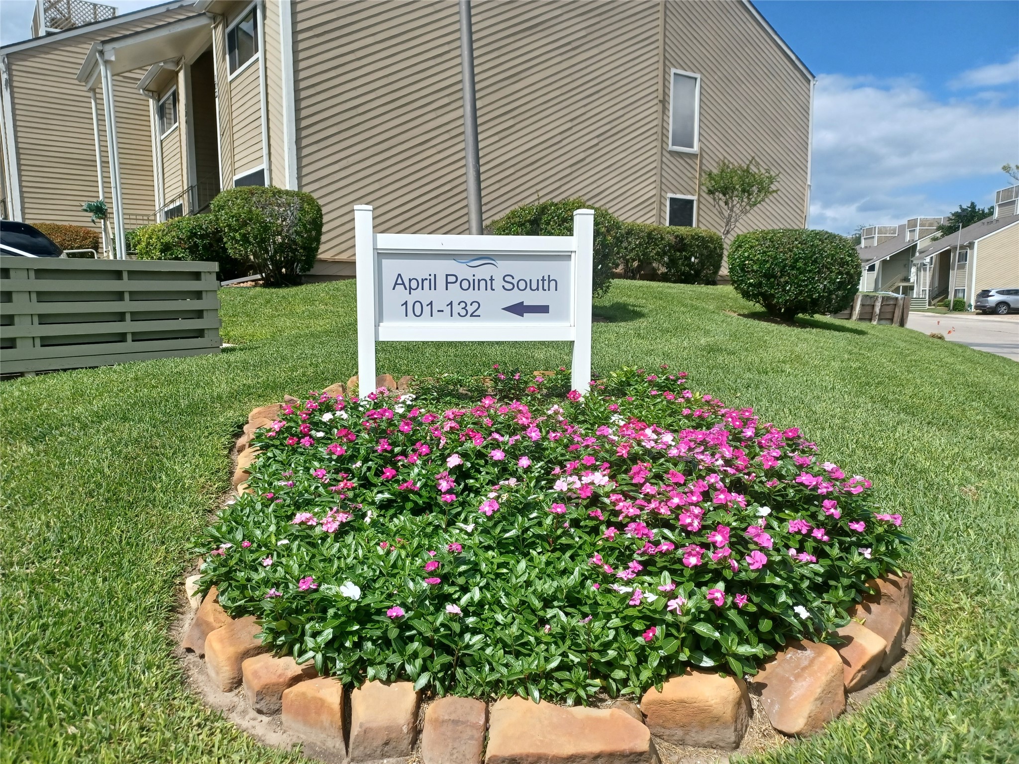 128 April Point Drive South Conroe, TX 77356 - Photo 2 of 26 a sign that is in front of flowers