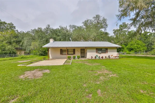 a front view of a house with yard porch and furniture