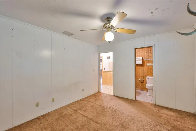a white toilet sitting next to a bathroom sink