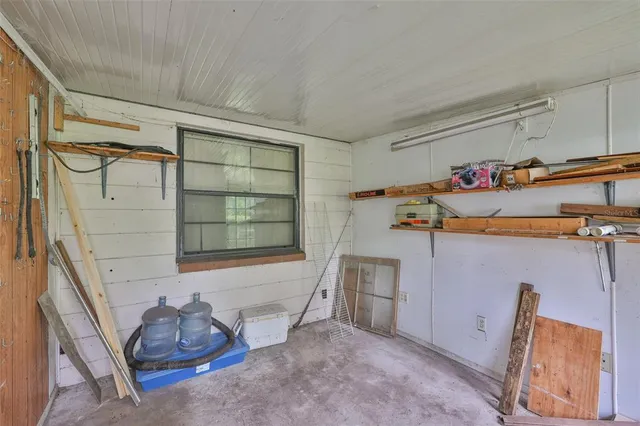 a room with a large window and dining table