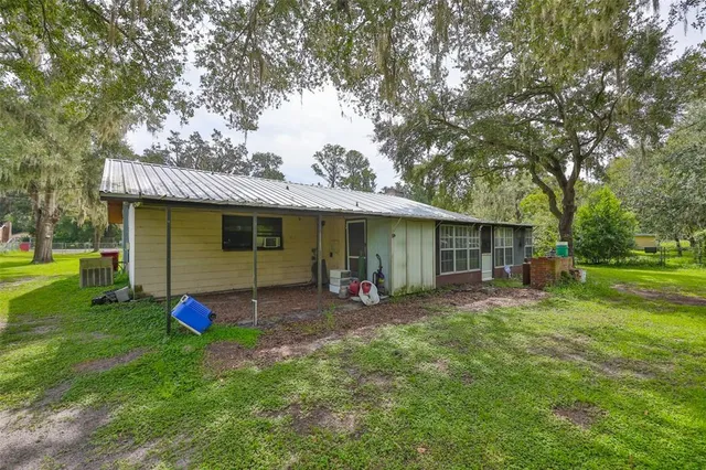 a view of a house with a yard and sitting area