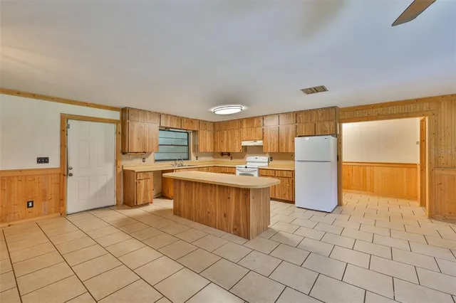 a kitchen with a sink appliances and cabinets