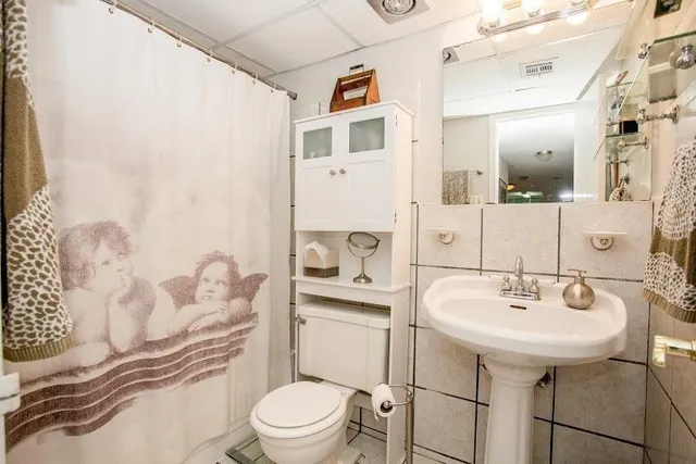 a bathroom with a sink toilet and shower