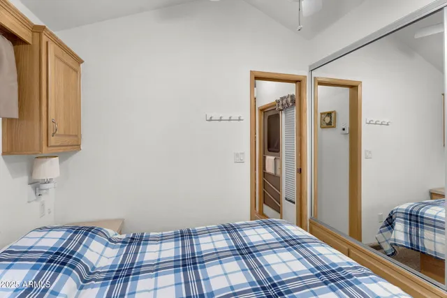 a bedroom with a bed and wooden floor