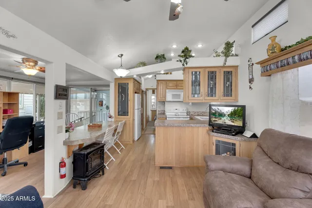 a living room with furniture a ceiling fan and a window