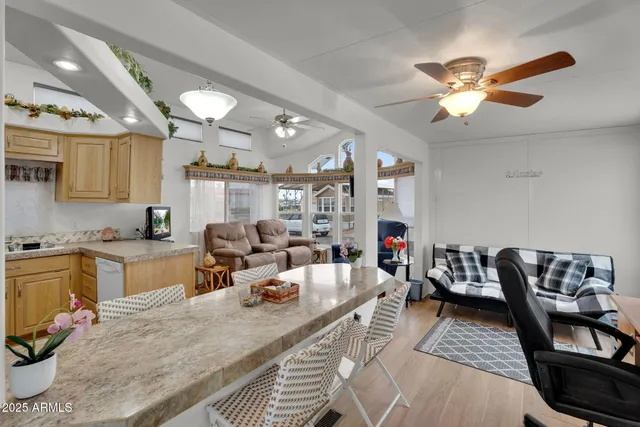 a view of a livingroom with workspace and a window