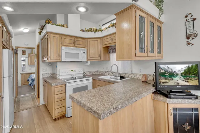 a living room with stainless steel appliances kitchen island granite countertop a stove and a view of living room