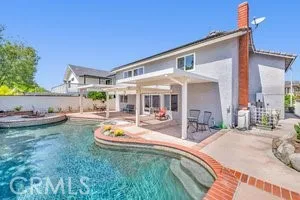 a view of a house with backyard and sitting area