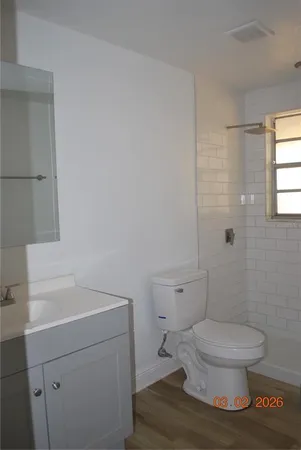 a white toilet sitting next to a bathroom sink