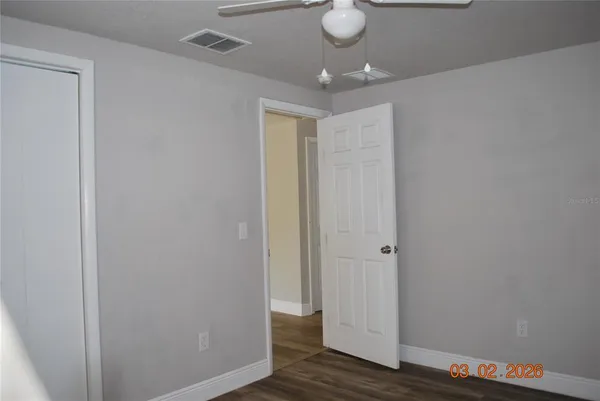a view of a hallway with wooden floor