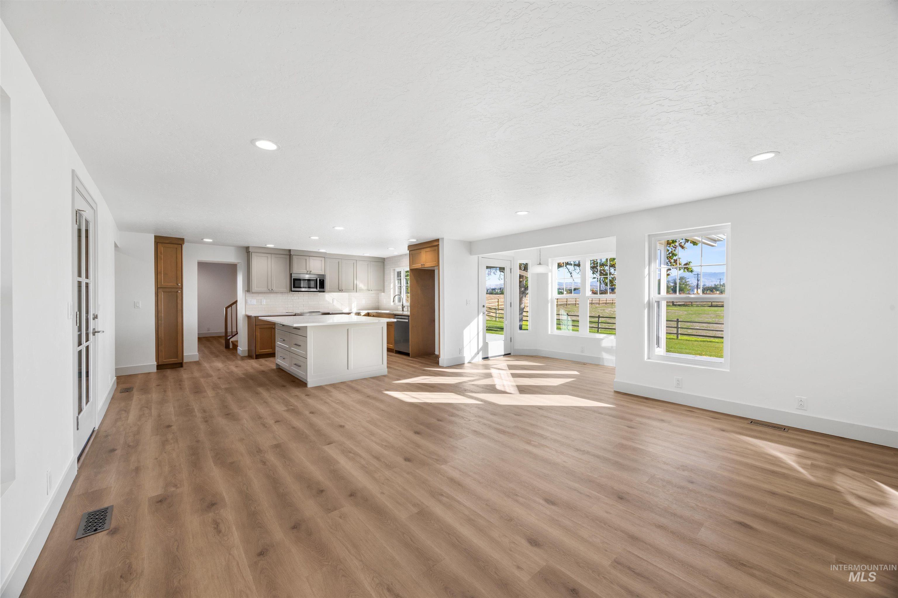 2141 West Beacon Light Road Eagle, ID 83616 - Photo 12 of 46 Unfurnished living room featuring recessed lighting and light wood-type flooring