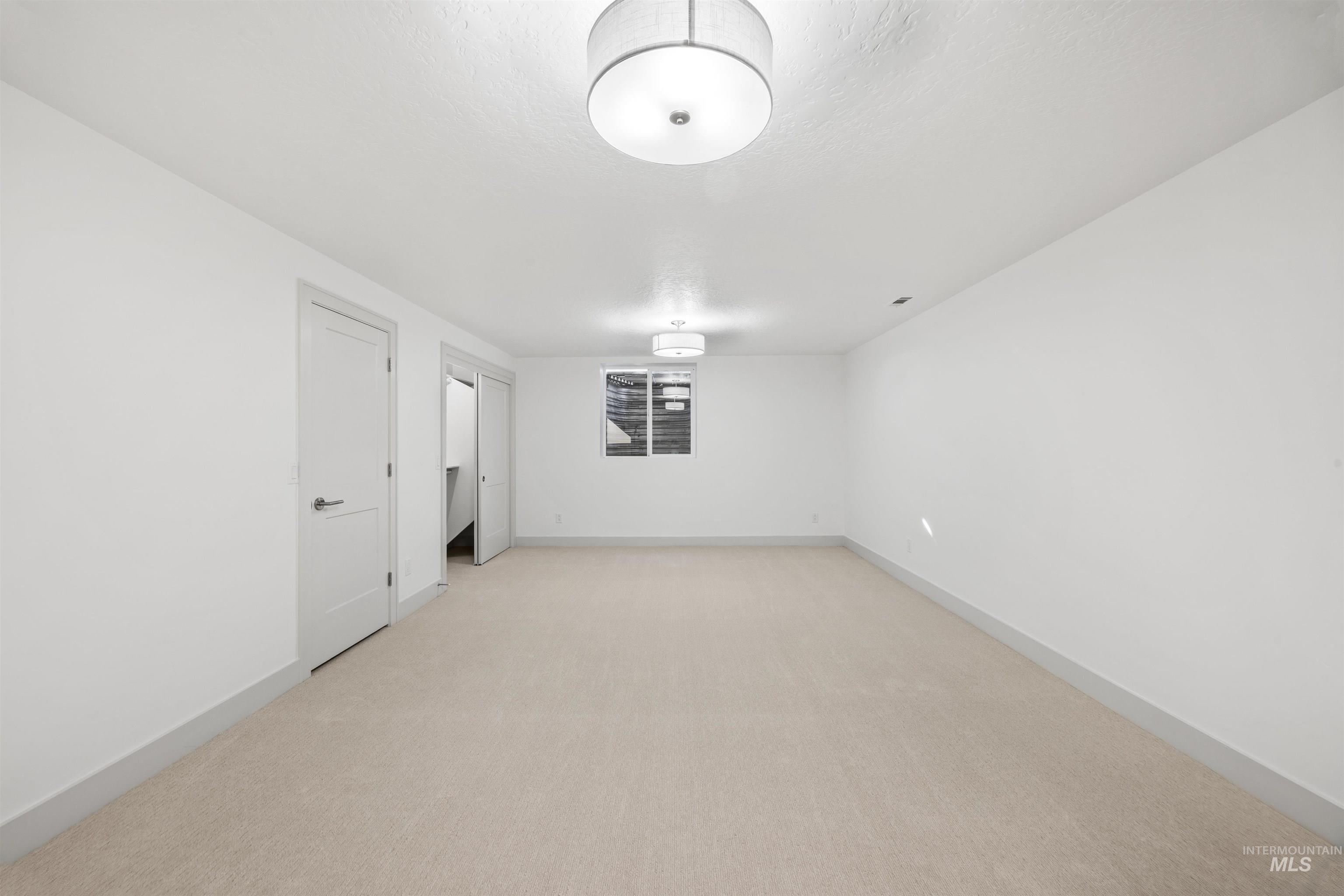 2141 West Beacon Light Road Eagle, ID 83616 - Photo 26 of 46 Spare room featuring light carpet and a textured ceiling