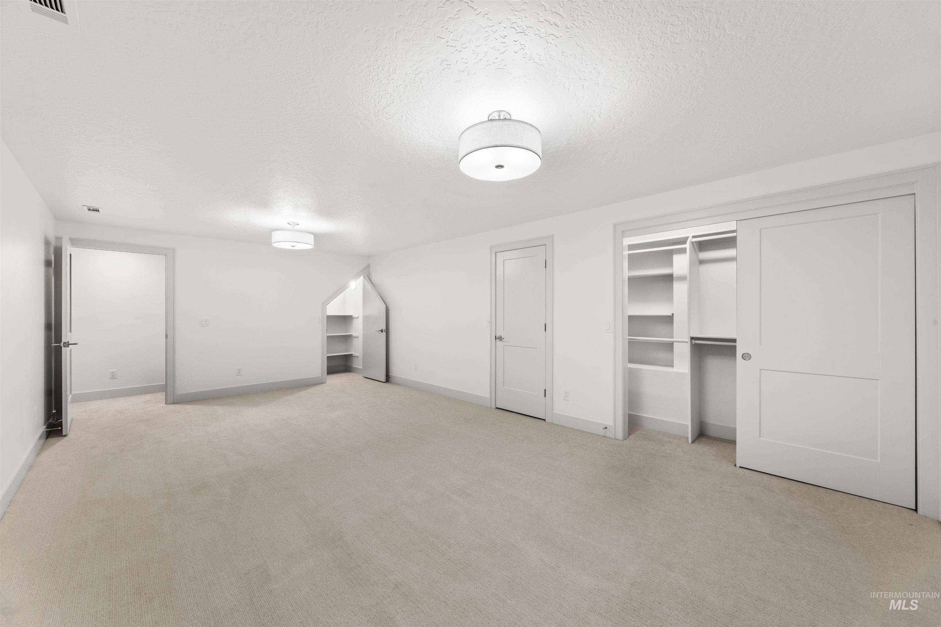 2141 West Beacon Light Road Eagle, ID 83616 - Photo 27 of 46 Unfurnished bedroom with a textured ceiling and light carpet