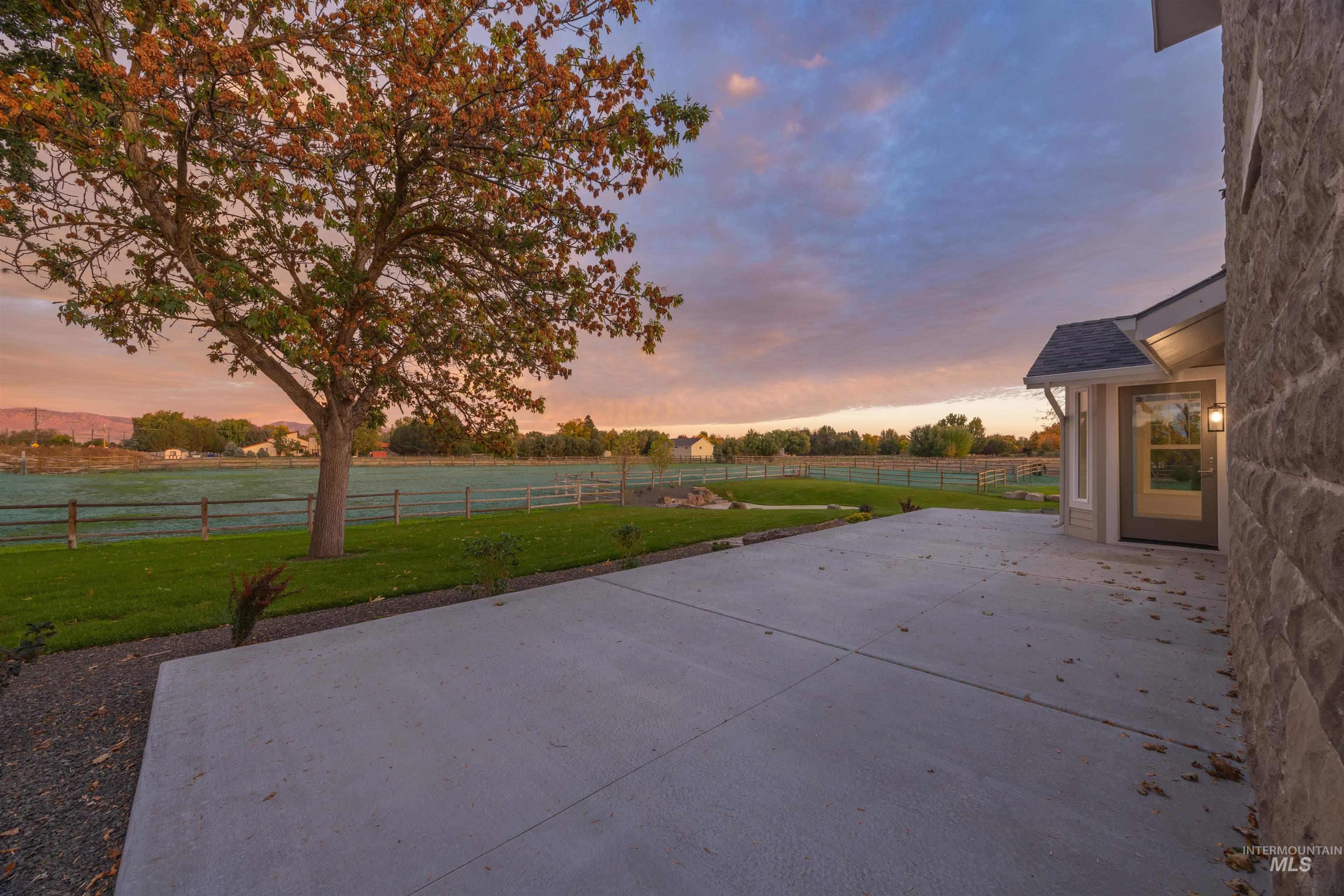 2141 West Beacon Light Road Eagle, ID 83616 - Photo 37 of 46 Fenced backyard featuring a patio and a rural view