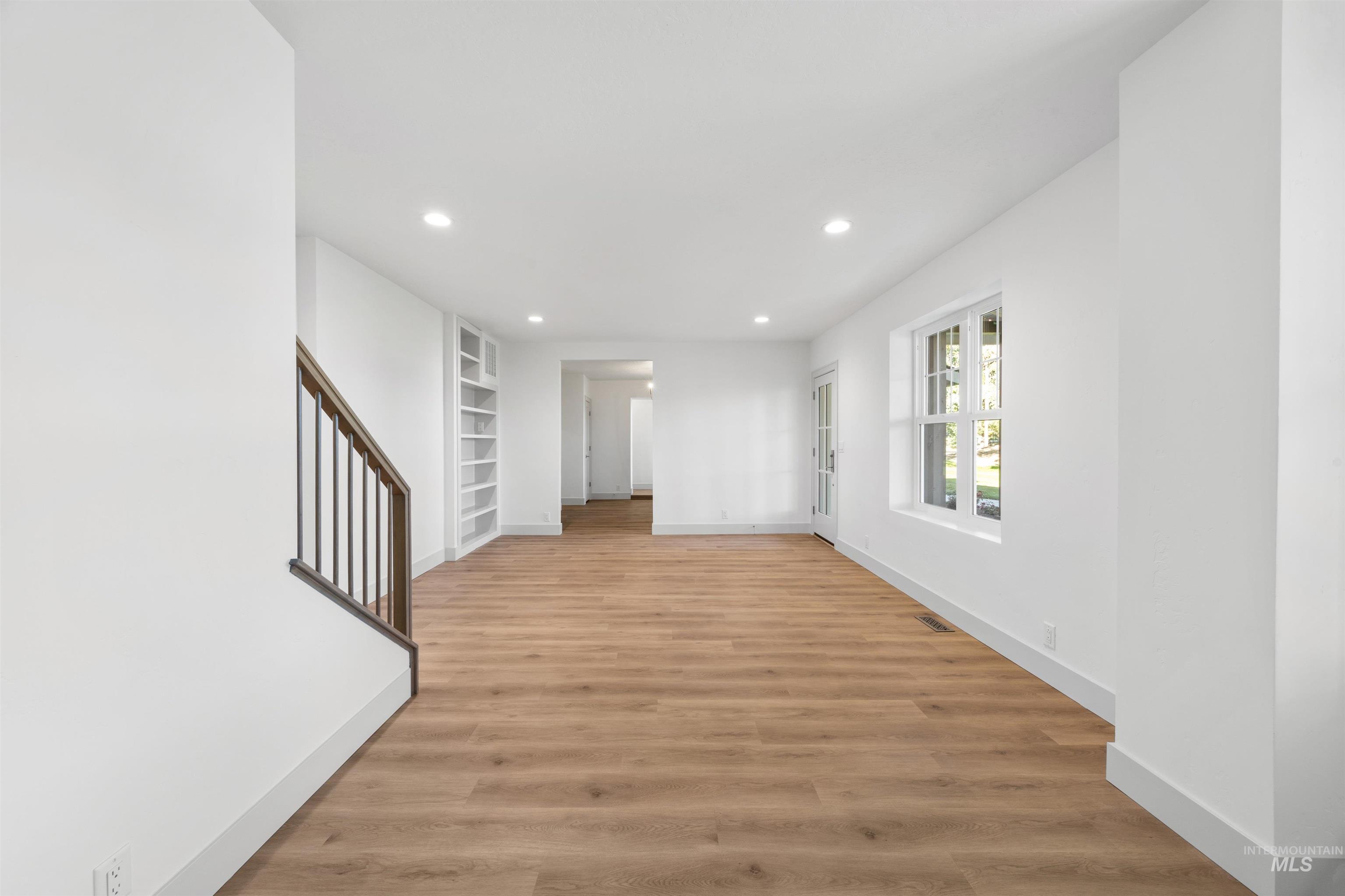 2141 West Beacon Light Road Eagle, ID 83616 - Photo 7 of 46 Unfurnished room featuring recessed lighting, light wood-style flooring, and built in shelves