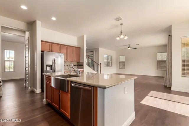 a kitchen with stainless steel appliances granite countertop a stove a sink and a microwave
