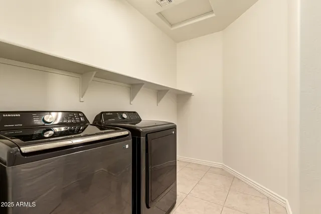 a large bathroom with a double vanity sink mirror and a bathtub