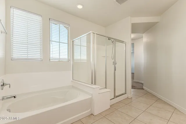 a bathroom with a granite countertop sink a mirror and a bathtub