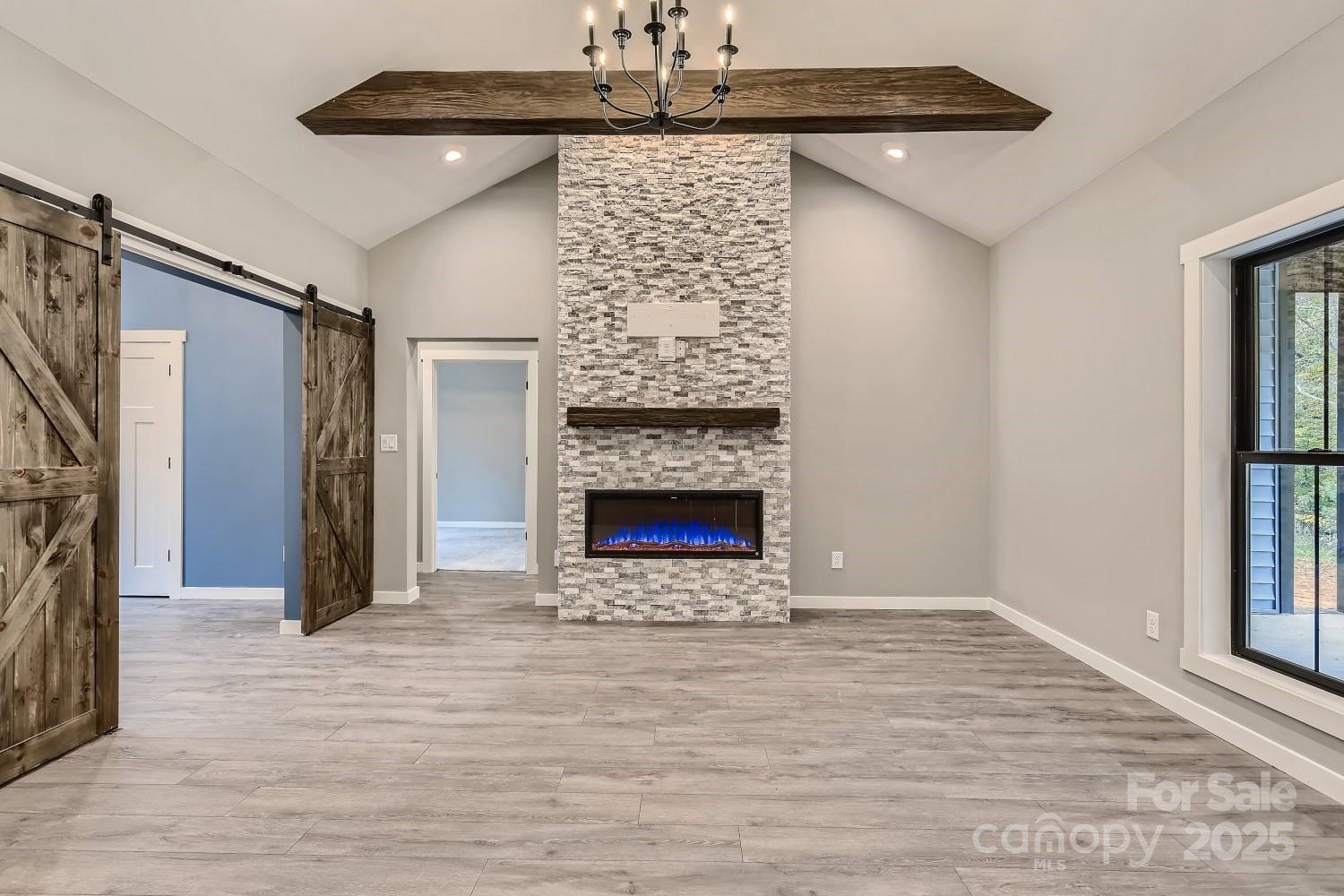 825 Potneck Road Salisbury, NC 28147 - Photo 12 of 40 a view of an empty room with wooden floor fireplace and a window