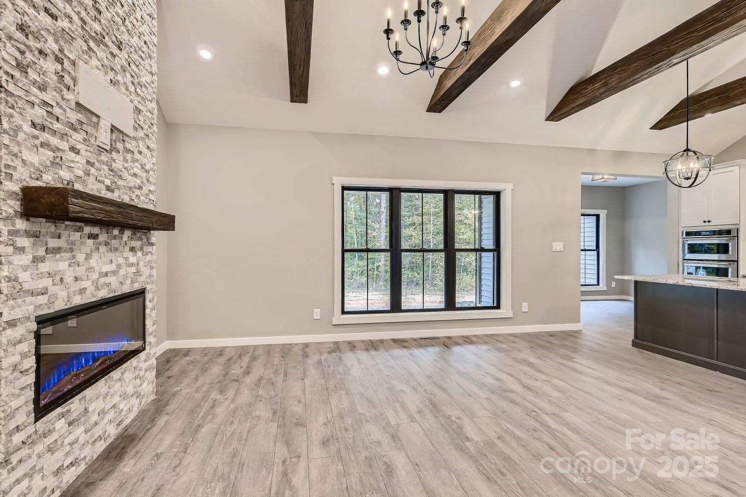 825 Potneck Road Salisbury, NC 28147 - Photo 13 of 40 wooden floor fireplace and windows in an empty room