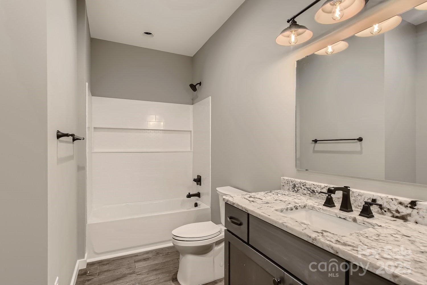 825 Potneck Road Salisbury, NC 28147 - Photo 15 of 40 a bathroom with a granite countertop sink toilet mirror and shower
