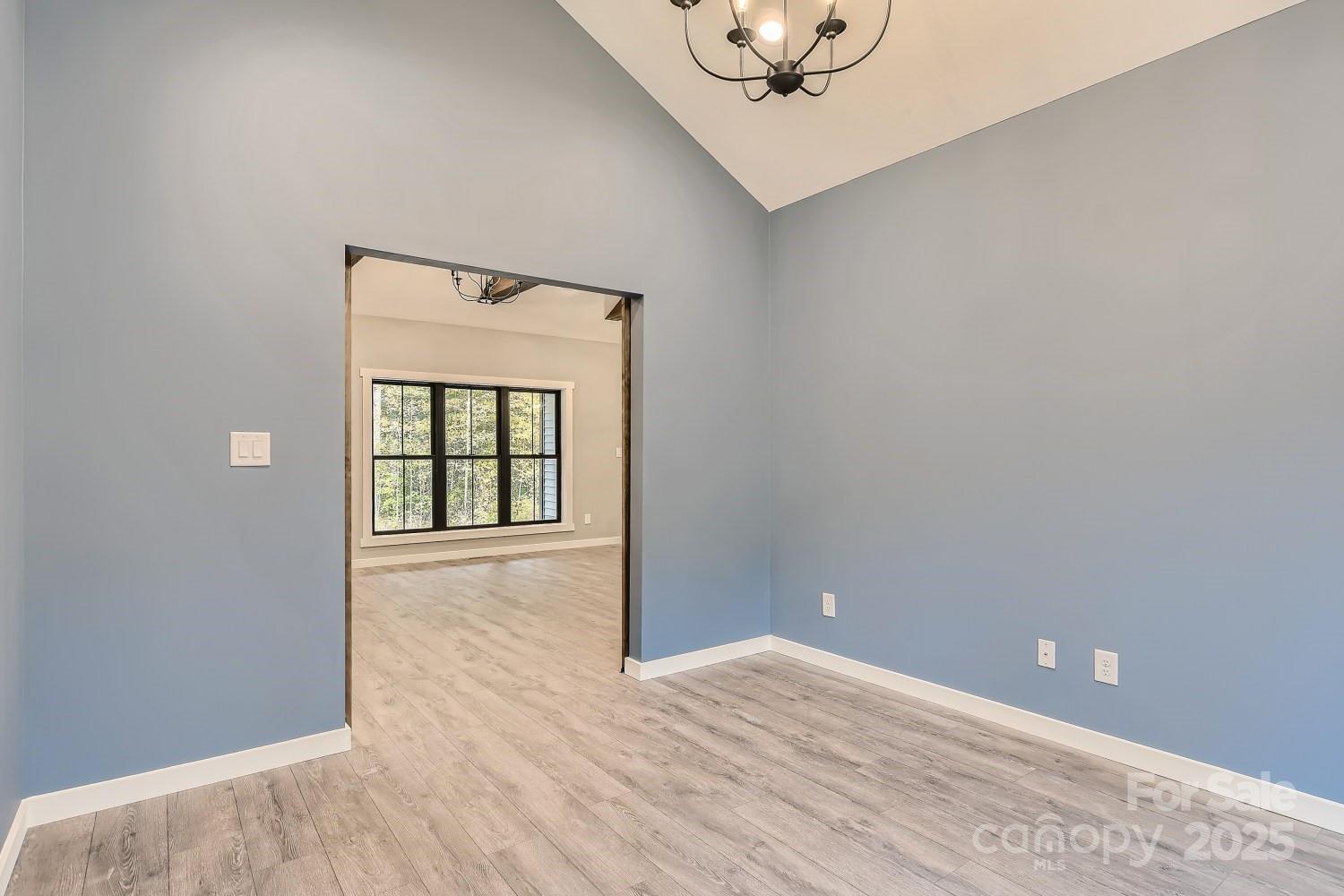 825 Potneck Road Salisbury, NC 28147 - Photo 18 of 40 a view of an empty room with wooden floor and a window